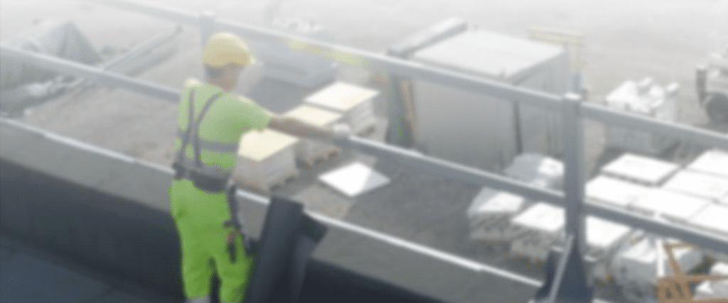 blurred picture of man looking down at construction site